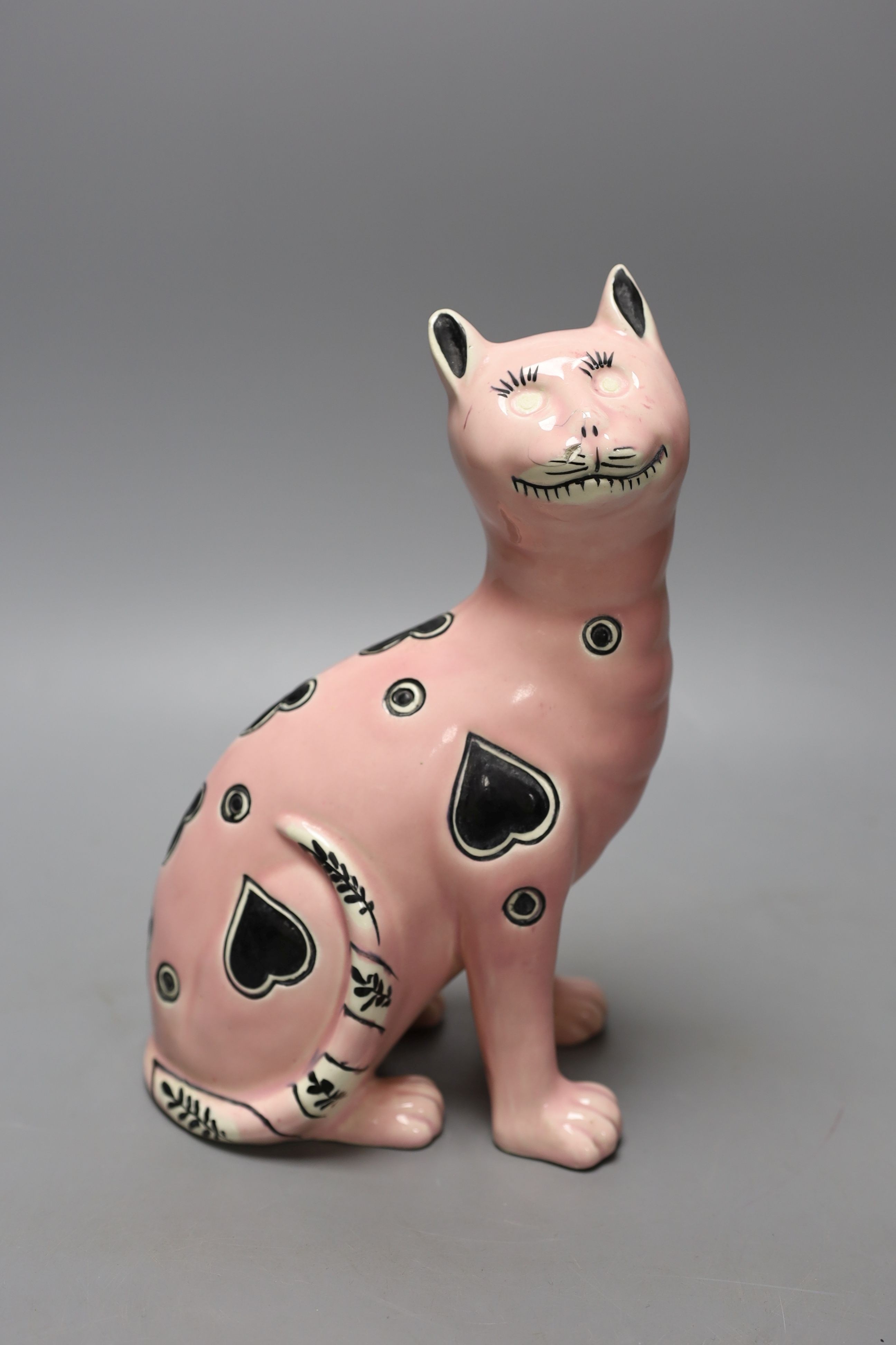 A Galle style pink glazed pottery model of a cat, early 20th century, impressed number 1896 to base, 24.5 cm high, eyes lacking